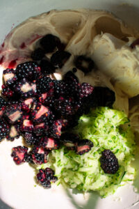 cake batter with blackberries and zucchini