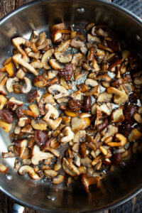 sautéed cremini mushrooms and shiitake mushrooms in a pan