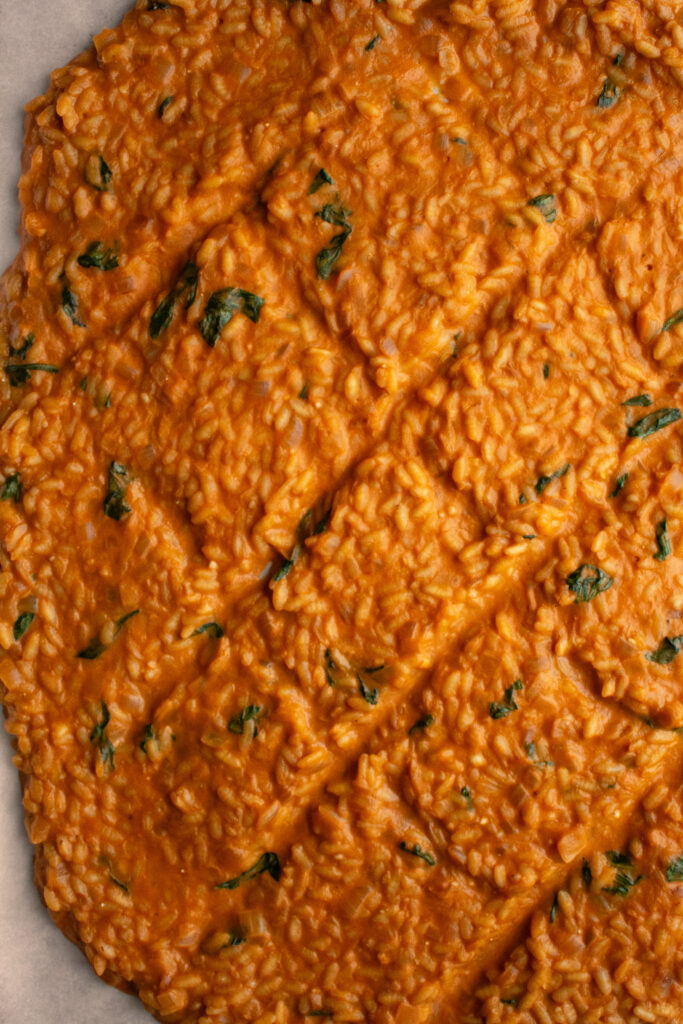 risotto spread out onto a sheet pan