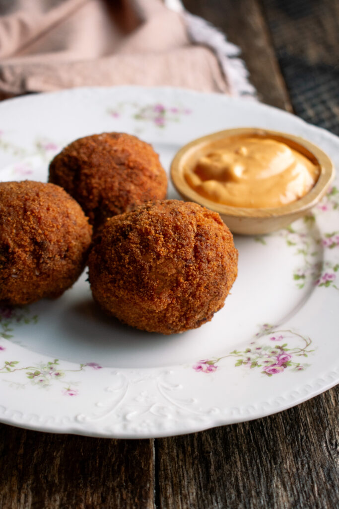 three arancini with a side of calabrian chili aioli