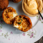 three arancini with a side of calabrian chili aioli