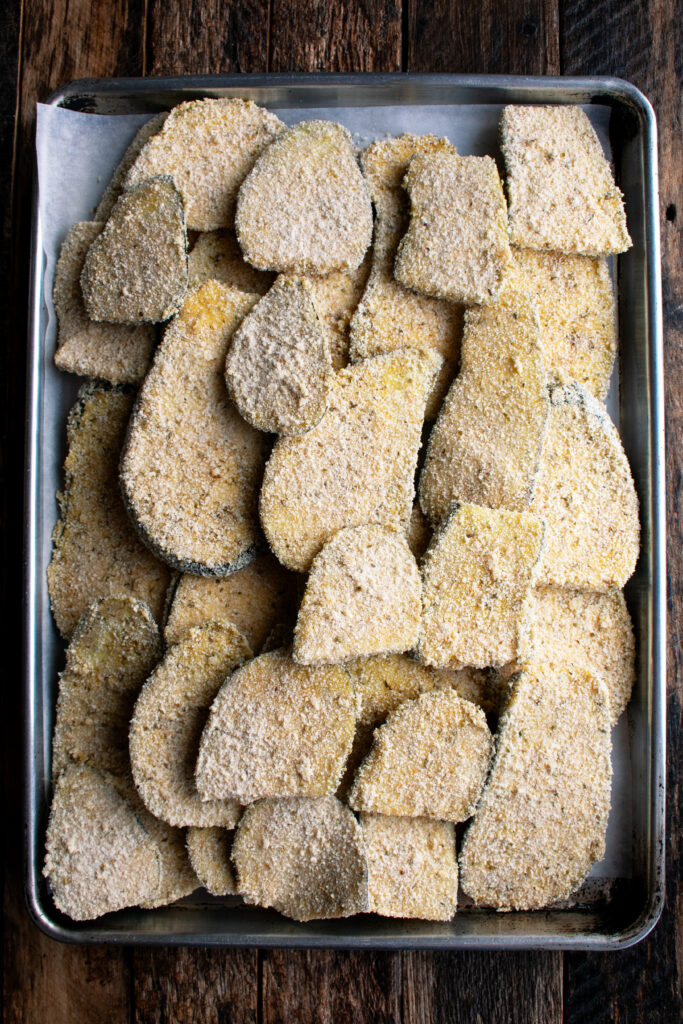 breaded eggplant slices on a sheet pan