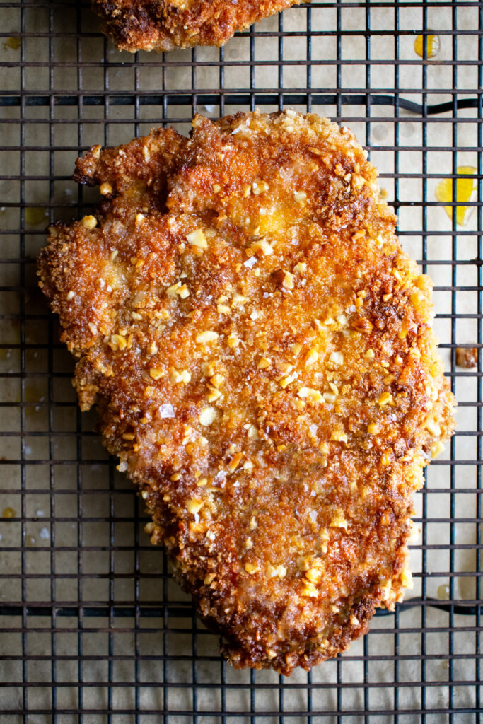 walnut crusted chicken on a sheet rack out of the oven