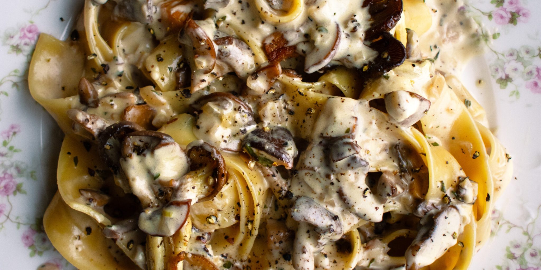 a plate of pappardelle pasta tossed in a creamy mushroom sauce